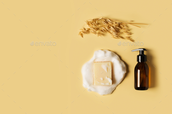 Liquid and bar natural eco soap lat lay on yellow background
