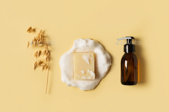 Liquid and bar natural eco soap lat lay on yellow background