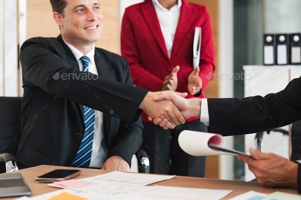 Business handshake for teamwork of business merger and acquisition, successful negotiate