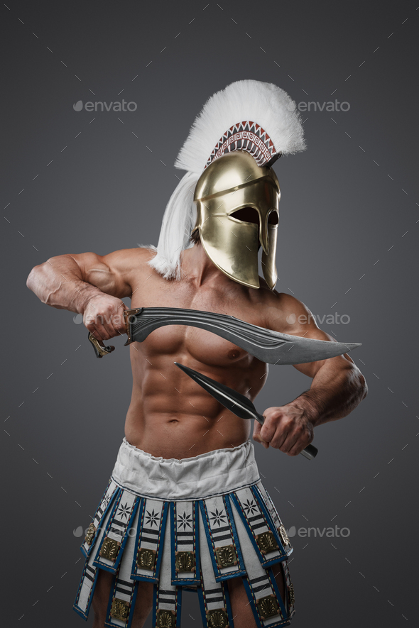 Combative greek warrior from past dressed in plumed helmet - Stock Photo - Images