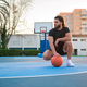 Portrait of a Latin Afro man posing with a ball on a basketball court - PhotoDune Item for Sale