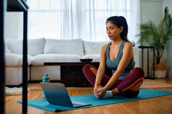 Female Athlete Using Laptop While Exercising At Home. Stock Photo By 