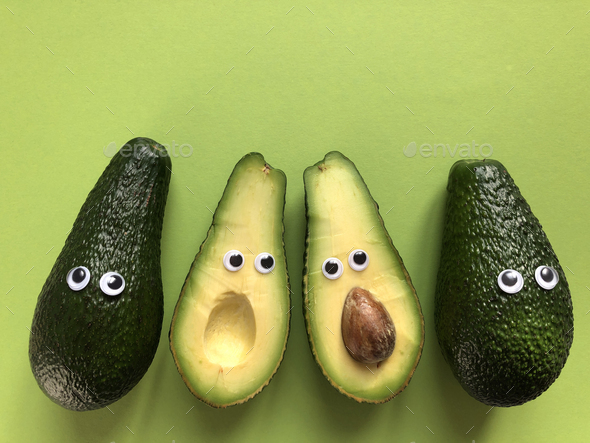 Avocados with googly eyes, whole and cut in half - Stock Photo - Images