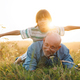 Little boy lay on a back on his grandfather laying on a grass in a field - PhotoDune Item for Sale