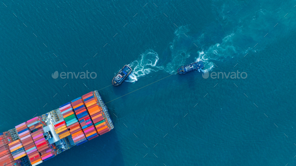 Tub Boat with Stern of cargo ship carrying container and running for import goods from cargo