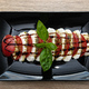 A simple salad with mozzarella cheese, tomatoes and basil leaves with balsamic dressing. - PhotoDune Item for Sale
