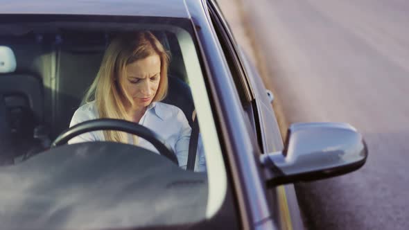 Woman Fastening Belt in Car