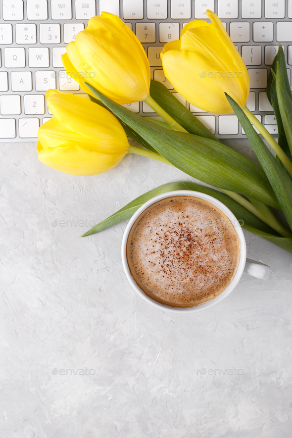 Yellow tulips cup of coffee and keyboard - Stock Photo - Images