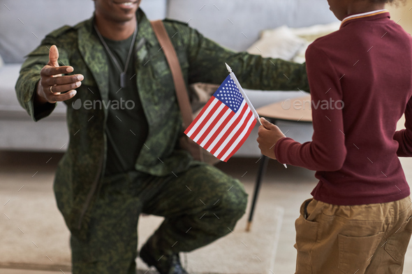 Girl with american flag meeting her dad