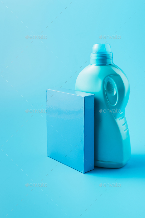 close up view of washing powder and laundry liquid, blue background