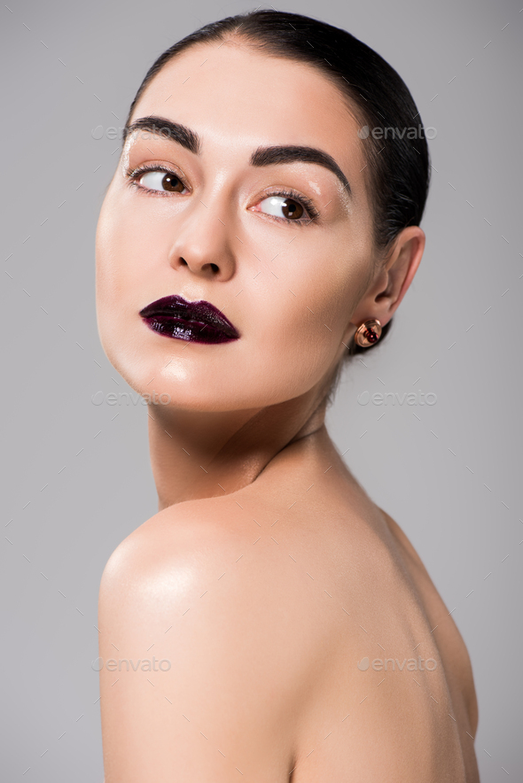 portrait of beautiful naked girl with black lips, isolated on grey