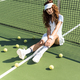 beautiful tennis player in stylish sportswear with racket sitting near tennis net on court with - PhotoDune Item for Sale