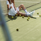 stylish female tennis player in sunglasses resting near net on tennis court with equipment near by - PhotoDune Item for Sale