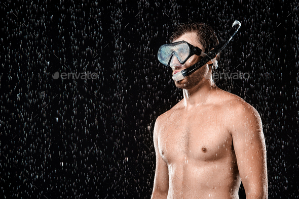 portrait of shirtless man in swimming mask with snorkel standing