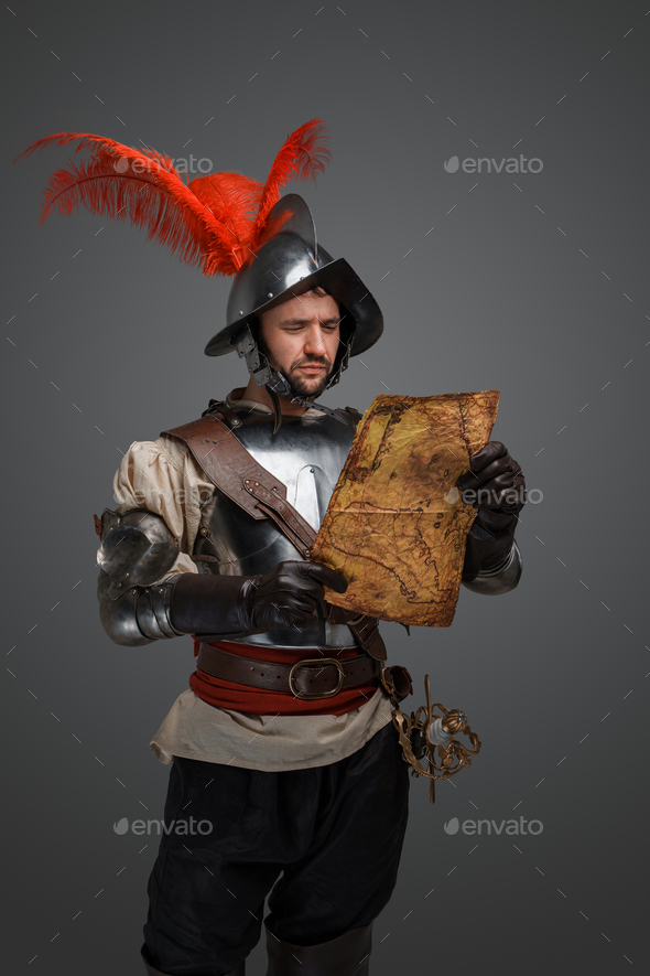 Conquistador dressed in armor and helmet exploring map - Stock Photo - Images