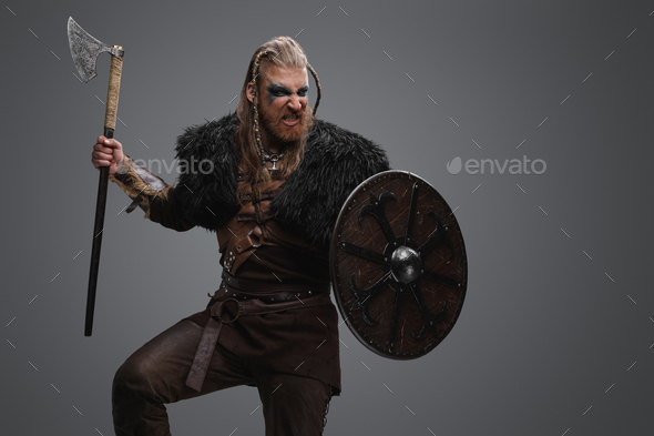 Attacking viking barbarian with rounded shield and axe Stock Photo by ...