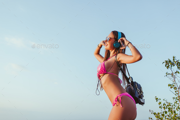 Teen girl in bikini against Blue sky, Stock Photo, Picture And