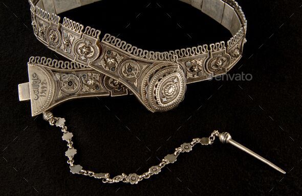 Antique, silver belt isolated on a black background, close-up