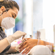 Selective focus shot of a manicurist doing manicure in a mask and gloves - concept of new normal - PhotoDune Item for Sale