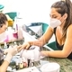 Shallow focus shot of a Hispanic female nail artist wearing a face mask painting a client&#39;s nails - PhotoDune Item for Sale