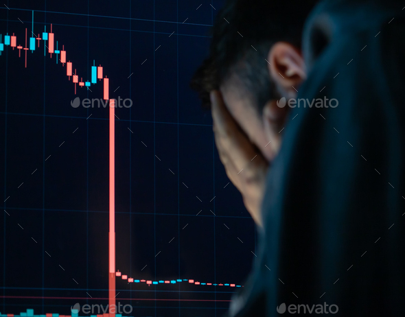 Frustrated depressed man holding head in hands shocked when global stock market going down. - Stock Photo - Images