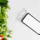 Eco vegetables, money and mobile phone mockup on white table. Smartphone with white empty display - PhotoDune Item for Sale