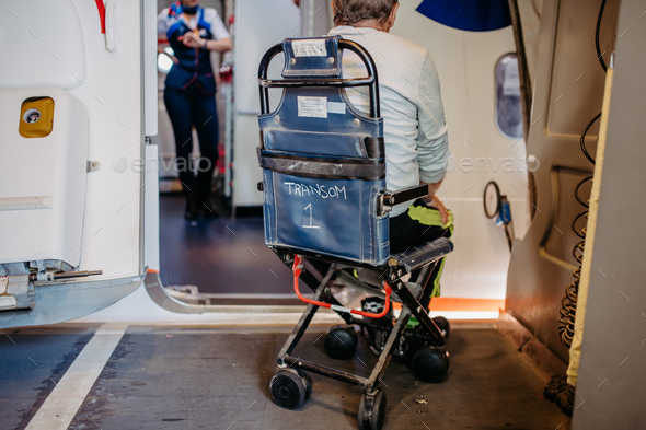 Rear view of man on special wheelchair for transport in the airplane. Concept of traveling with
