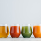 Assorted multicolored juice in jar standing at row against white background - PhotoDune Item for Sale