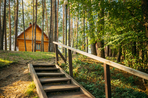 Tourist Guest House For Rest. Wooden House In Forest In Autumn Sunny Day
