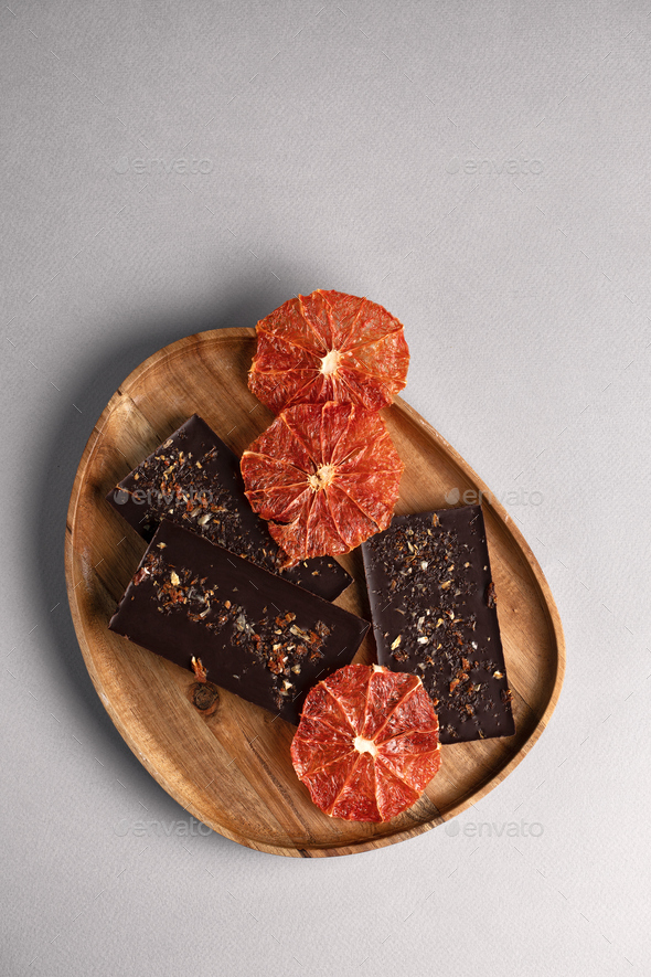 chocolate bar with grapefruit. spices are sprinkled on the surface