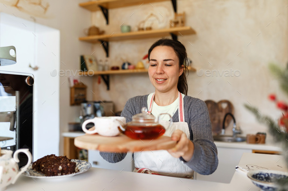 Happy young woman in apron, startup come true. Small business concept. Family business, cafe place.
