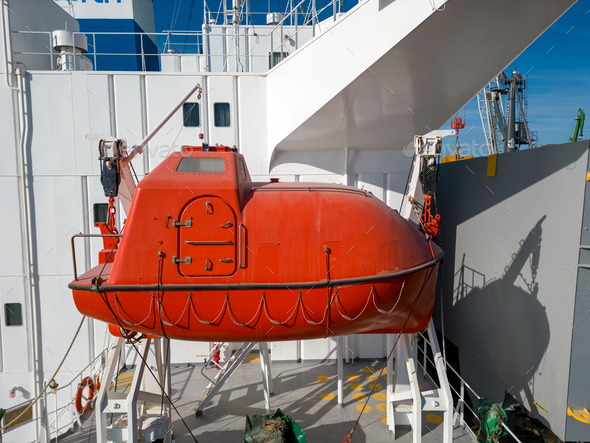 lifeboat on a cargo ship, for emergency evacuation. The boat is seen up ...