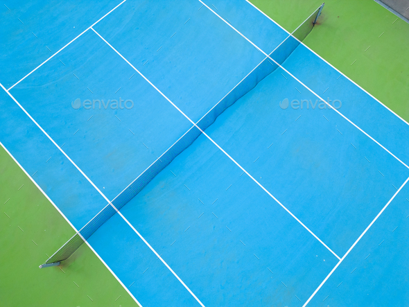 aerial view of a serene blue-green tennis court in an empty state