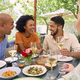 Group Of Friends Enjoying Outdoor Meal And Wine On Visit To Vineyard Restaurant - PhotoDune Item for Sale