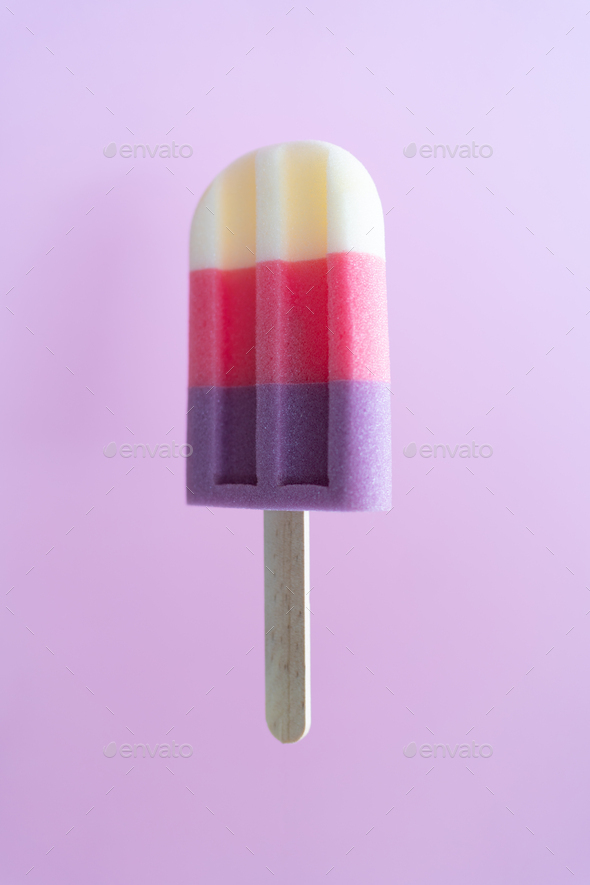 Colored ice cream popsicle on a pastel purple background. Minimal summer concept - Stock Photo - Images