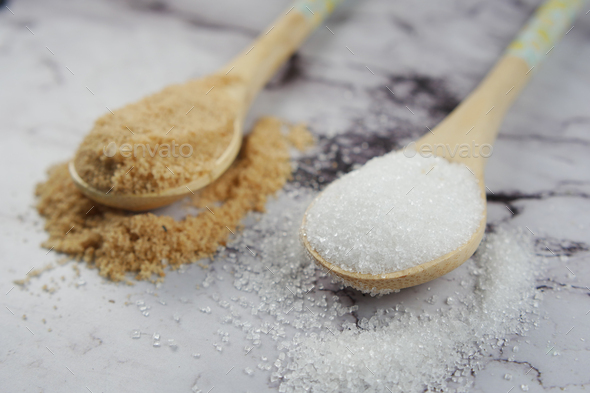 comparing white and brown sugar on table  - Stock Photo - Images