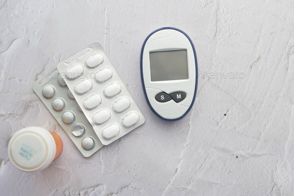 diabetic measurement tools and medical pills on table  - Stock Photo - Images