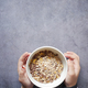  child hand holding a bowl of Musli breakfast cereal  - PhotoDune Item for Sale