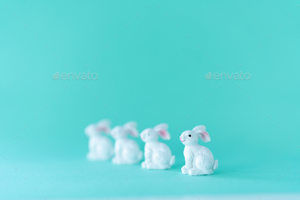 Eggs white easter bunnies, the first one in focus, the others blurred - Stock Photo - Images
