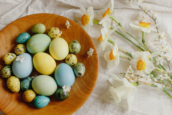 Happy Easter! Rustic easter flat lay. Stylish easter eggs and blooming daffodils flowers