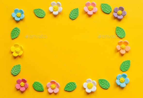 Stylish colorful flowers flat lay on yellow background - Stock Photo - Images