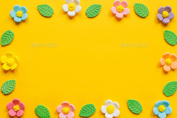 Stylish colorful flowers flat lay on yellow background - Stock Photo - Images