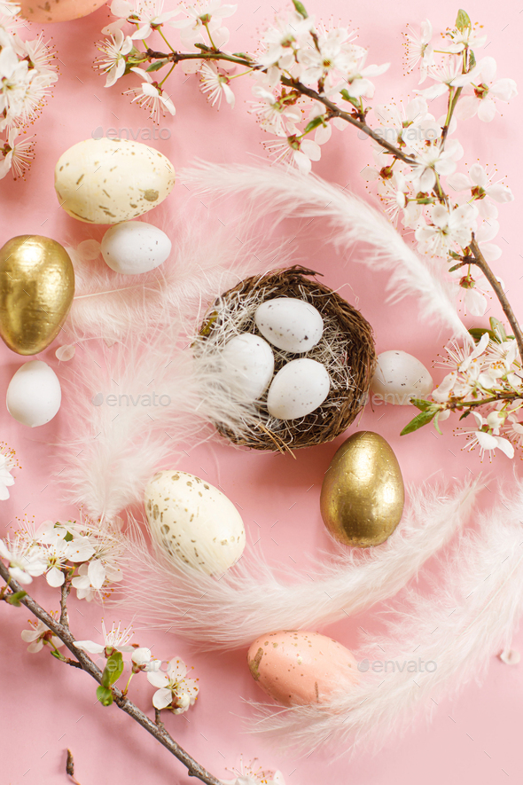 Happy Easter! Easter flat lay with stylish eggs in nest, feathers and blooming cherry branch - Stock Photo - Images