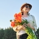 Portrait of beautiful mature healthy happy woman with bouquet of poppies - PhotoDune Item for Sale