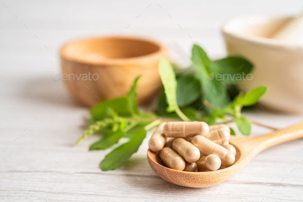 Alternative medicine herbal organic capsule drug with herbs leaf n  - Stock Photo - Images