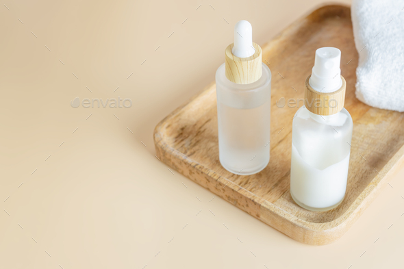 Set of skin care cosmetics - cream pump bottle and essense bottle with beauty serum or fluid