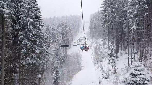 Ski lift passing through the snowy fir forest