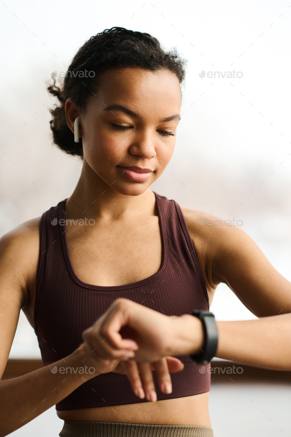 Fitness girl checking her fitness bracelet - Stock Photo - Images
