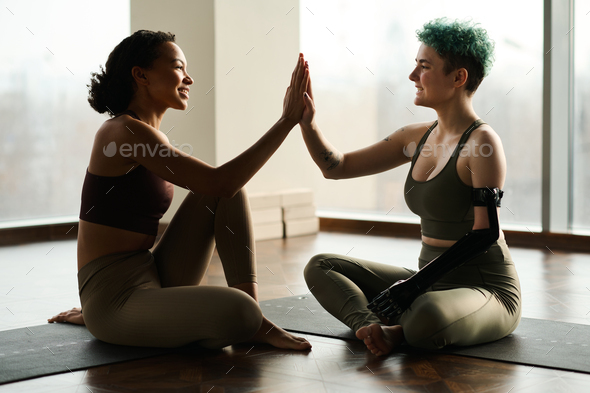 Girl with disability greeting yoga instructor - Stock Photo - Images