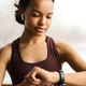 Fitness girl checking her fitness bracelet - PhotoDune Item for Sale